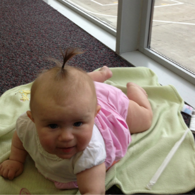 Baby in an Airport on a Green Blanket