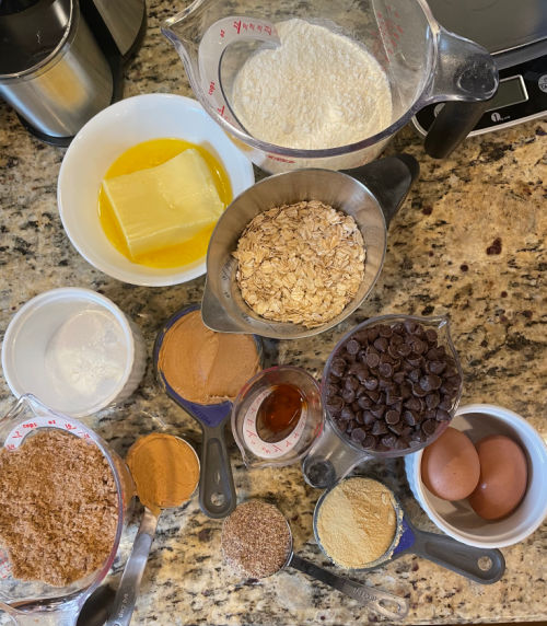 Ingredients in Peanut Butter Chocolate Chip Lactation Bars - flour, butter, oats, chocolate chips, 2 eggs, vanilla, brewer's yeast, flaxseed, peanut butter, brown sugar, baking powder, baking soda, salt