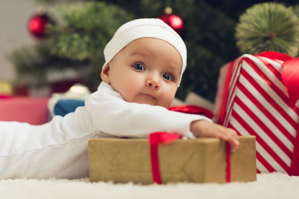 baby under a Christmas tree