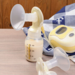 breast pump parts with breast milk in bottles