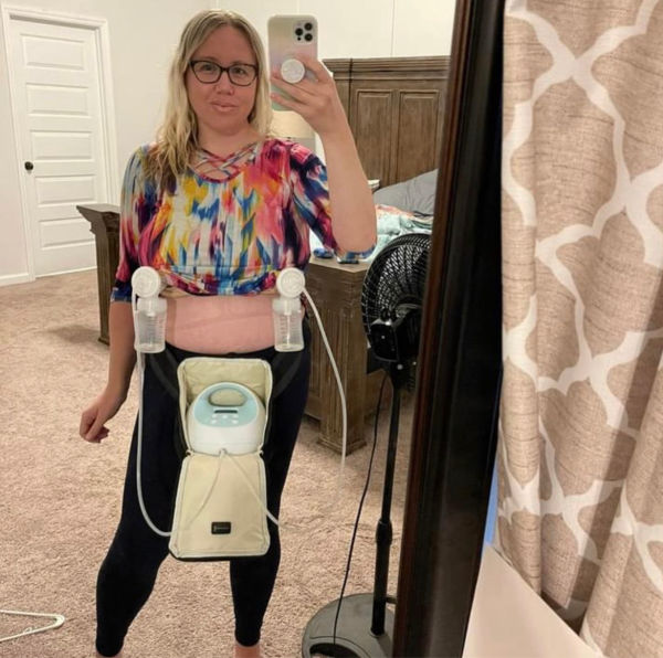 Woman pumping with a Spectra while wearing it in a fanny pack
