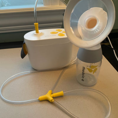 Medela max flow breast pump set up to single pump on a desk