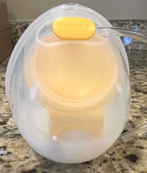 Medela wearable cup on a counter