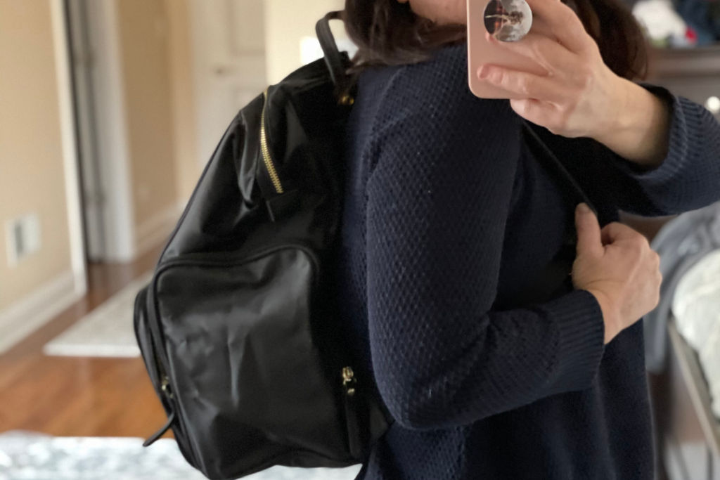 woman wearing breast pump backpack bag