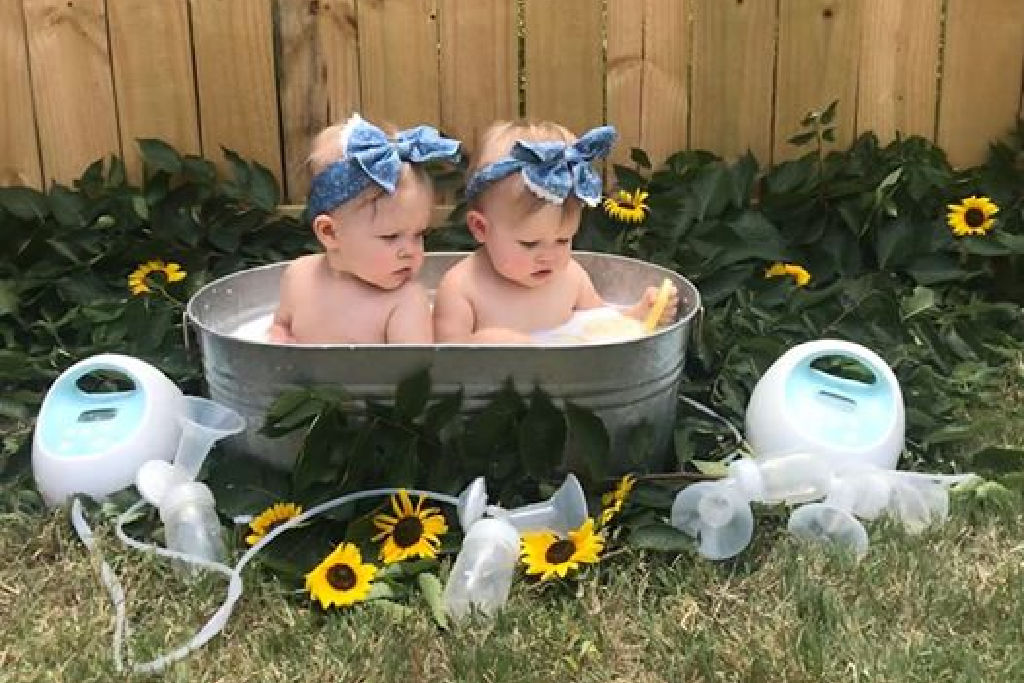 twin babies taking a breast milk bath