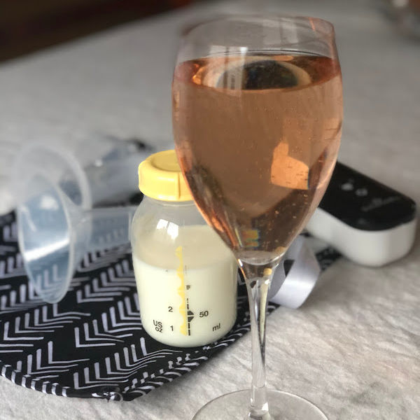 glass of wine in front of a breast pump