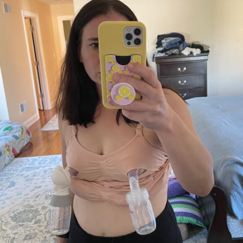Woman taking picture in a mirror wearing nude Kindred Bravely Sublime hands-free pumping bra set up for hands-free pumping