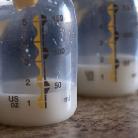bottles of breast milk with about 1 oz of milk