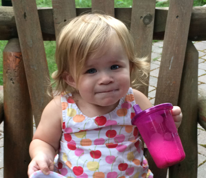 toddler drinking out of a sippy cup