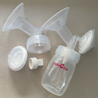 spectra breast pump parts on a flat surface